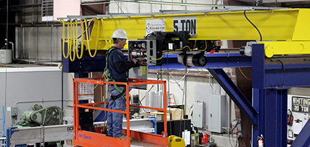 TSOC technician on a lift performing an inspection for a 5 ton overhead bridge crane.
