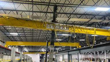 15 ton refurbished crane being installed inside a facility.