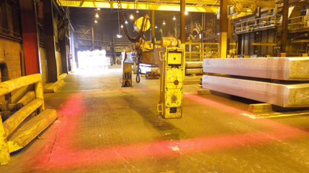 Safety zone around below-the-hook device formed by overhead crane lights.