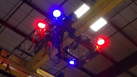 4 red and blue Straits overhead crane warning lights mounted to a crane.