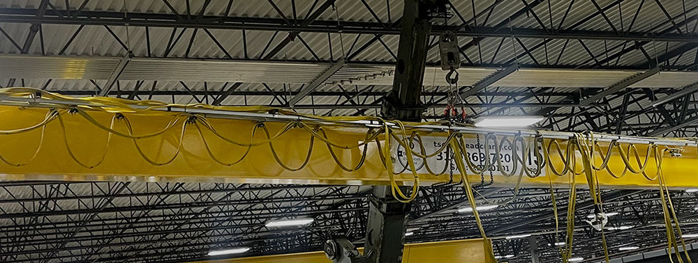 Refurbished overhead bridge crane being installed in a new location.