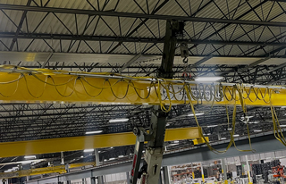 Refurbished overhead bridge crane being installed in a new location.