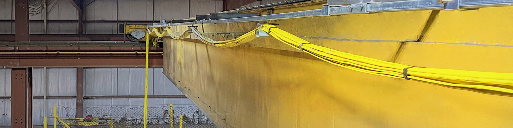 Newly installed flat cable festoon and c-track for 40 ton overhead bridge crane.
